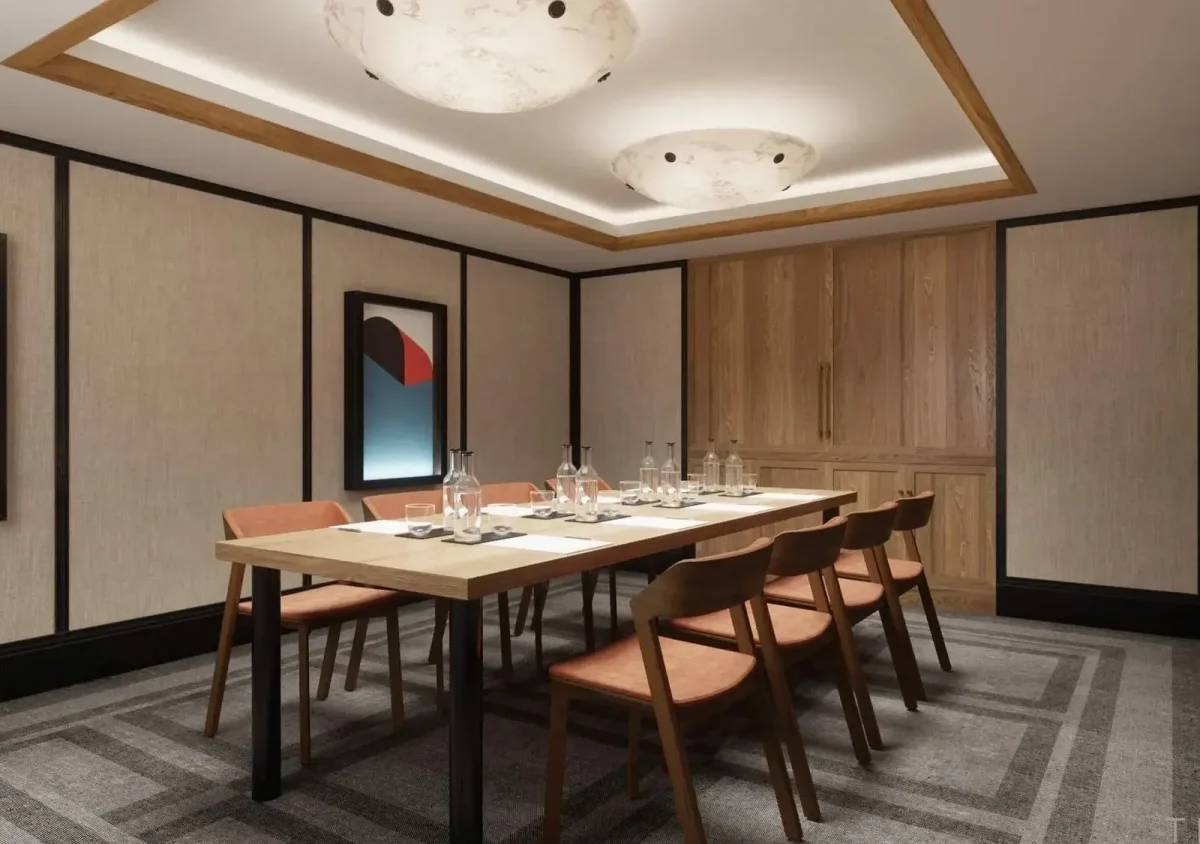 A modern conference room with a rectangular wooden table set for six, brown chairs, abstract wall art, and ceiling lights.